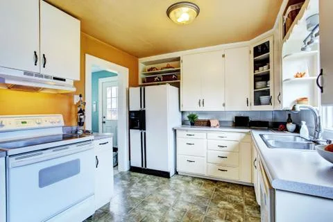 White kitchen interior with peach walls and khaki linoleum Stock Photos