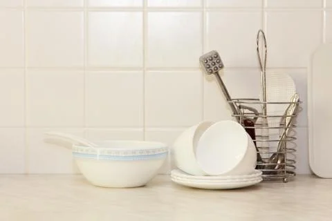 White kitchenware on kitchen table. Stock Photos