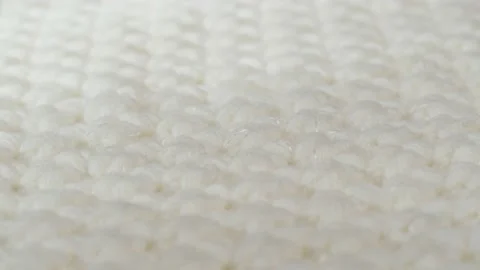 White knitted cloth, light woolen clothes fabric close-up, woven textile Stock Footage 168897276
