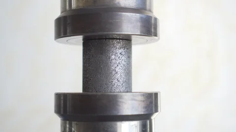In the white laboratory, the heavy press puts pressure on the graphite cylinder Stock Footage 115930045