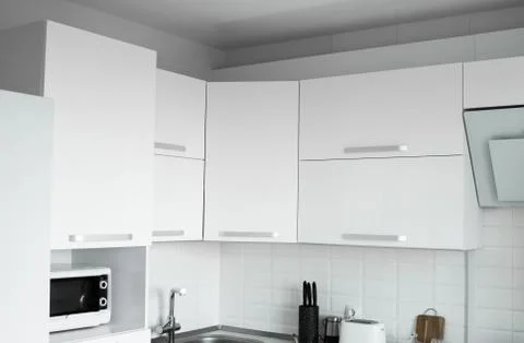 White lacquered kitchen facades on a comfortable kitchen. Modern white kitchen Stock Photos