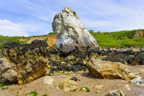 White Lady quartzite sea stack on Porth Padrig beach, Anglesey. Stock Photos