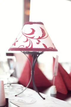 White lamp with red patterns on a table Stock Photos