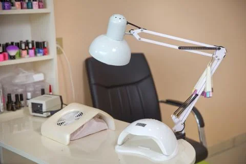 White lamp on white table with nail tool . Work place of nail amster with man Stock Photos