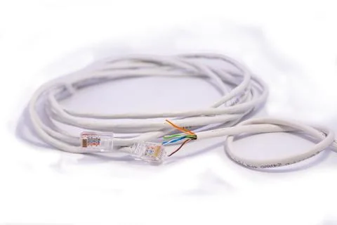 White lan cable rolled in circle on white background Stock Photos