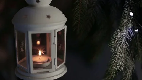 A white lantern with a candle on a background of Christmas lights Stock-Footage 70394139