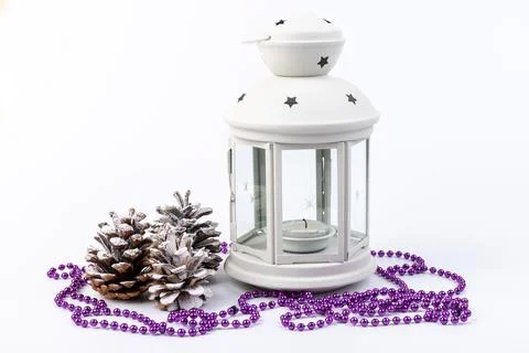 White lantern with candle inside and Christmas decoration on white background Stock Photos