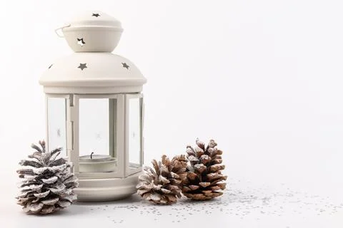 White lantern with candle inside and Christmas decoration on white background Stock Photos