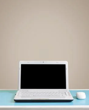 White laptop on table - place for text. Stock Photos