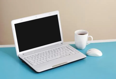 White laptop on table - place for text. Stock Photos
