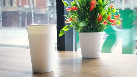 White large paper cup of tea on a table in a cafe. Stock Footage 152818095