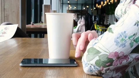 White large paper cup of tea on a table in a cafe. Stock Footage 152818832