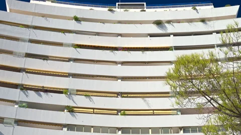 A white, large, pyramid-shaped building in the Marina Baie des Anges complex in Vídeos de archivo 306410147