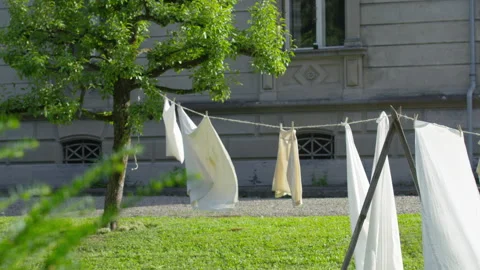 White laundry drying on a line in the Backyard Stock Footage 263297662