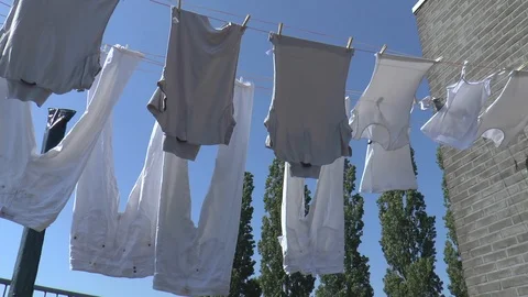 White Laundry Hanging on Clothesline in the Wind Stockbeeldmateriaal 86290157