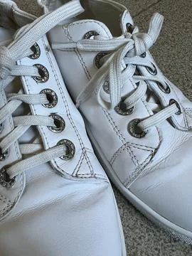 White leather sneakers close-up, with white laces Stock Photos