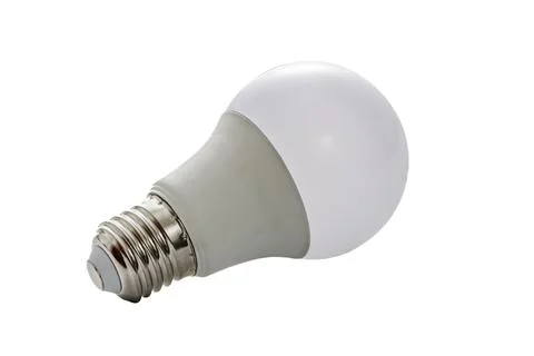 A white LED lamp with an E27 base lies on a white insulated background Stock Photos