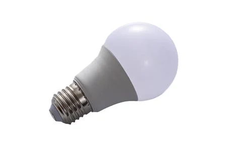 A white LED lamp with an E27 base lies on a white insulated background Stock Photos