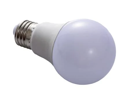 A white LED lamp with an E27 base lies on a white insulated background Stock Photos
