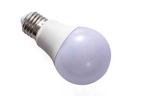 A white LED lamp with an E27 base lies on a white insulated background Stock Photos