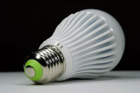 White LED lamp with E27 screw socket providing bright and even light for room Stock Photos