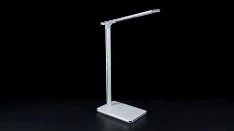White LED table lamp on black background Stock Footage 152934412