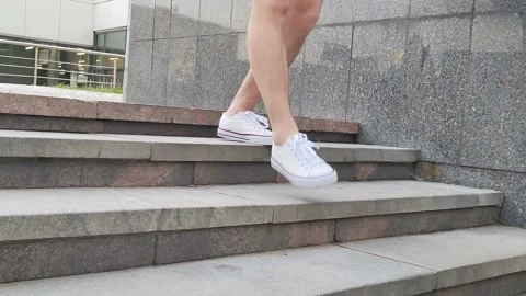 The white legs of a man go down the stairs Stock Footage 201303318
