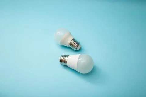 White light bulb on a blue background Stock Photos