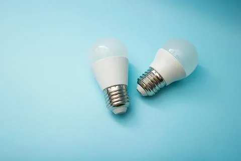 White light bulb on a blue background Stock Photos