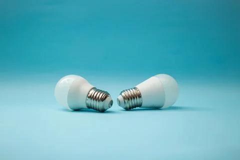 White light bulb on a blue background Stock Photos