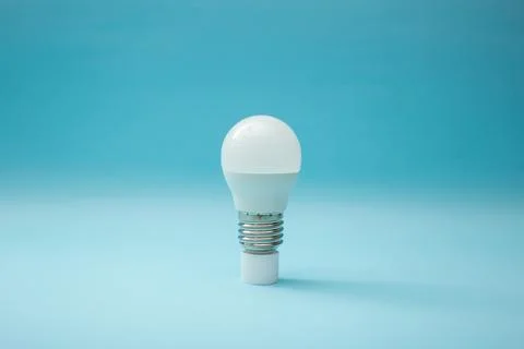 White light bulb on a blue background Stock Photos