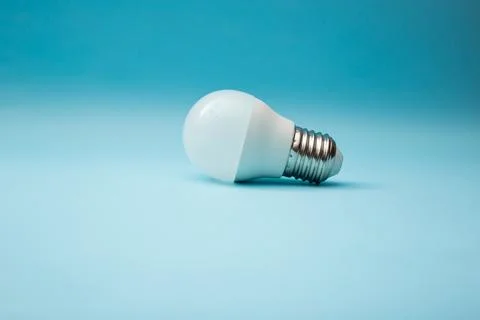 White light bulb on a blue background Stock Photos