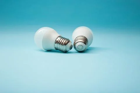 White light bulb on a blue background Stock Photos