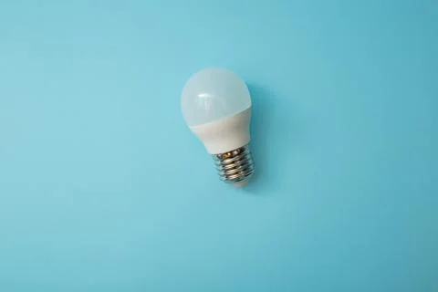 White light bulb on a blue background Stock Photos