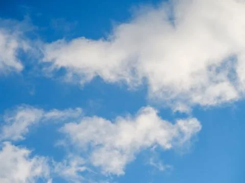 White light clouds against a sky Stock Photos