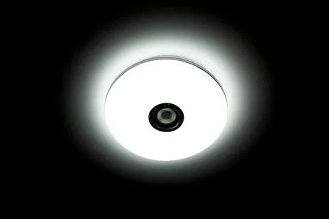 White light LED ceiling light with built-in wireless speakers over black ba.. Stock Photos