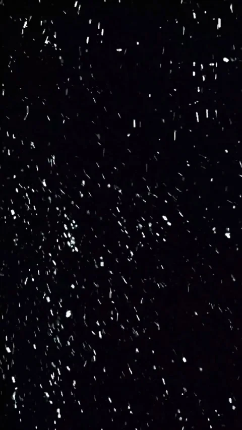 White light particles moving horizontally across a dark black background for Video stock 347692512