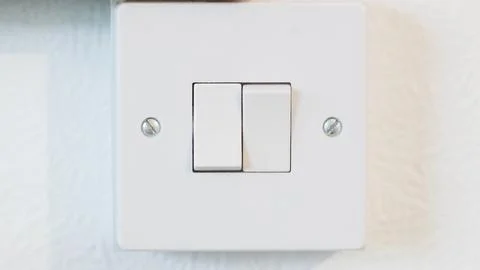 White light switch on textured wall with modern design elements Stock Photos