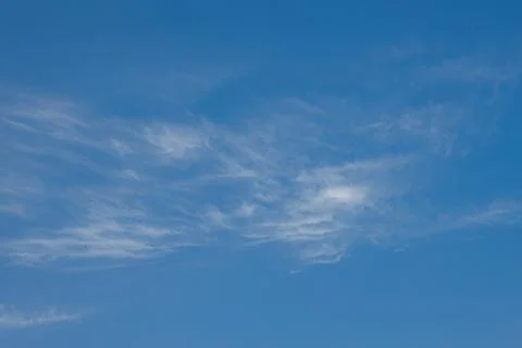 White light transparent clouds in the blue sky. Abstraction. Background. Stock Photos