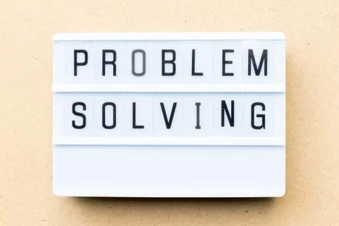 White lightbox with word problem solving on wood background Foto stock
