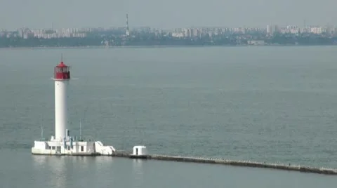 White lighthouse with the city in the background Stock Footage 10851002