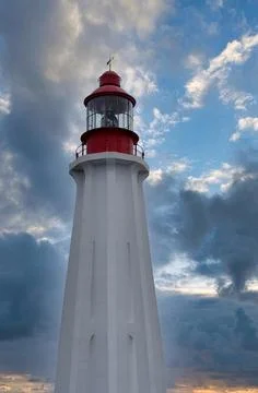 White Lighthouse with dramatic blue sky in Rimouski, Quebec, Canada Stock Photos