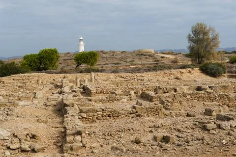 White lighthouse far away in cloudy weather Stock Photos