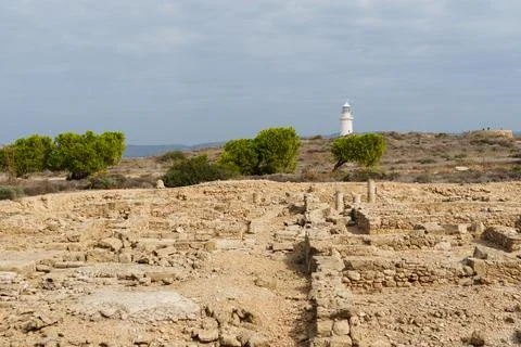 White lighthouse far away in cloudy weather Stock Photos