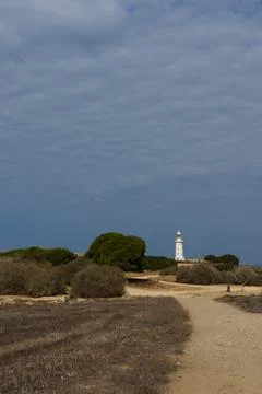 White lighthouse far away in cloudy weather Stock-Fotos
