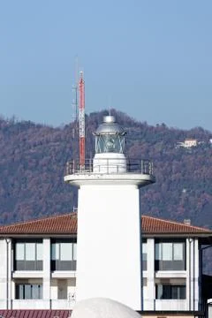 White lighthouse in a harbour Stock Photos
