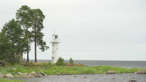 The white lighthouse on the hill on the side of the sea Stock Footage 140539102