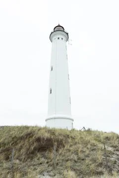 White lighthouse on the ocean Stock Photos