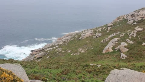 White lighthouse on rocky coastal cliff overlooking ocean in Punta Roncadoir Stockbeeldmateriaal 340990086
