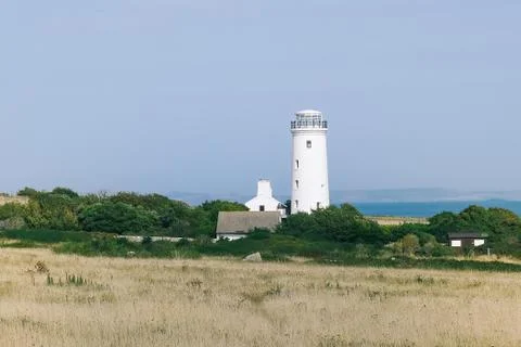 A white lighthouse on the seaside Stock Photos